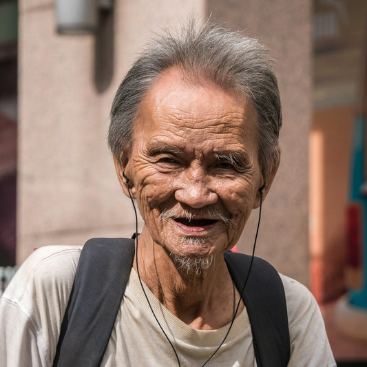 smiling man wearing grey backpack