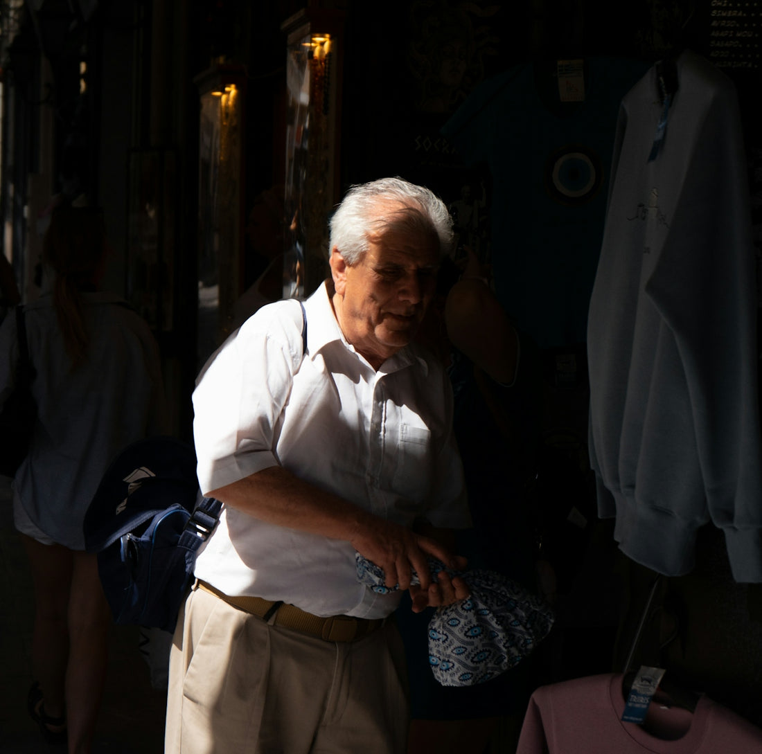 Elderly man in a white shirt and tan pants